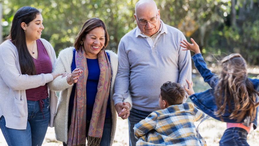 Multiple generations of a family enjoying a walk together in the outdoors.