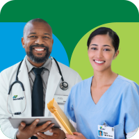 Doctor in a white coat and nurse in light blue scrubs, holding a clip board and smiling warmly at the viewer.